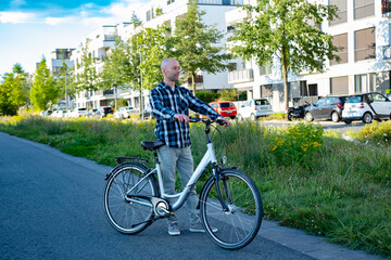 Fototapeta premium young man enjoying bike ride through modern European city, Men cycling through frankfurt cityscape, exploring urban landscapes and embracing eco-friendly travel