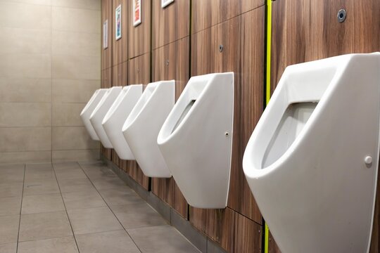 Modern and Hygienic Urinals. White urinals in men's toilet.