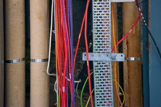 An electrical conduit system and a metal pipeline are installed on the building ceiling