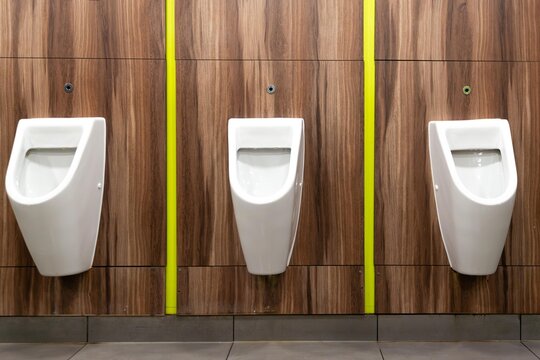 Modern and Hygienic Urinals. White urinals in men's toilet.