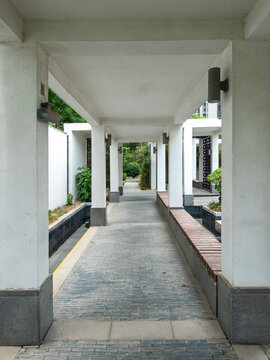 Covered walkway with traditional Chinese style architectural elements in a garden
