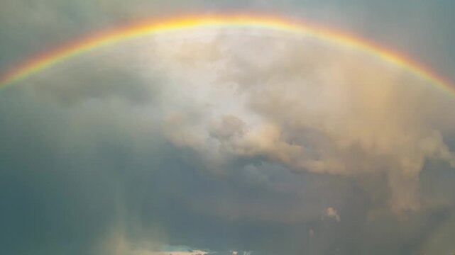 Rainbow glows softly in the sky. Rainbow arcs across gentle clouds. Rainbow brings calm after rain. Rainbow shines with quiet hope.