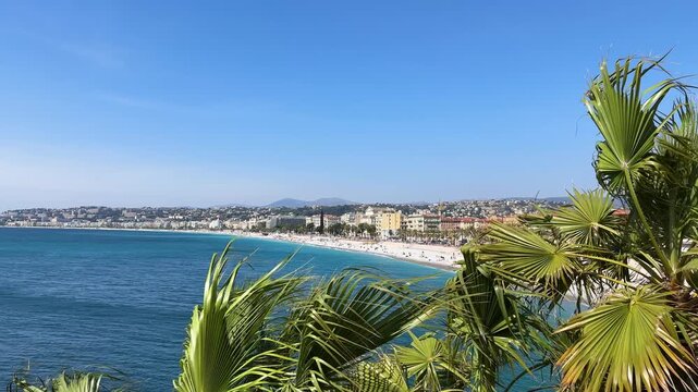 Wind on the observation deck in Nice. Palm leaves sway in the strong breeze overlooking the azure coast of Nice. Vacation 2026 Europe