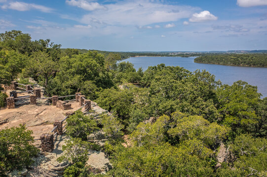 Aerial Drone View of Blue Lake Surrounded by Forest of Green Trees With Rocky Landscape in Lake Mineral Wells State Park in Mineral Wells, Texas
