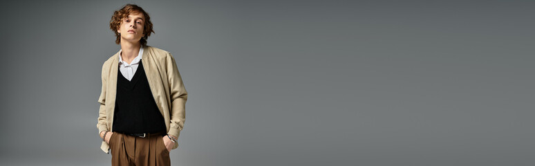 Stylish handsome man in fashionable outfit poses confidently in a modern studio setting