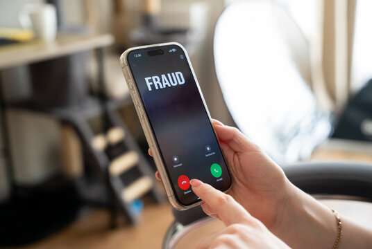 A woman receives a call from scammers. Personal data protection and awareness of phone fraud. Rules for avoiding scams, cybersecurity threats and social engineering attacks.