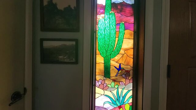 Intricate Stained Glass Featuring Agave And Cactus Motifs Illuminates Hallway With Colorful Patterns
