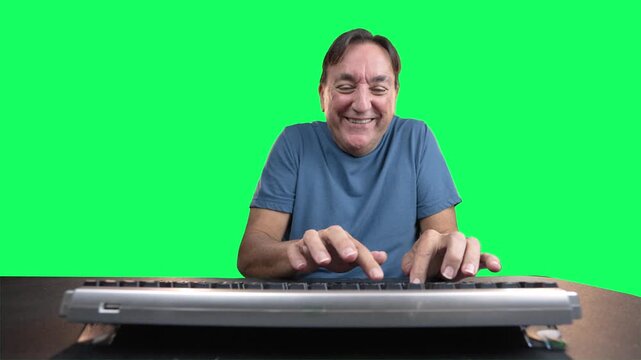 Smiling man aggressively typing on computer keyboard on green screen background. Humorous concept of online trolling, keyboard warrior behavior, or excited internet posting. 15092  