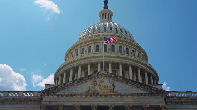 Capitol monument under sky. Patriotic capitol with American flag. Historic capitol facade closeup. Federal capitol in Washington DC.