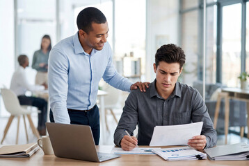 Obraz premium Young men collaborate with supportive gesture over papers in office