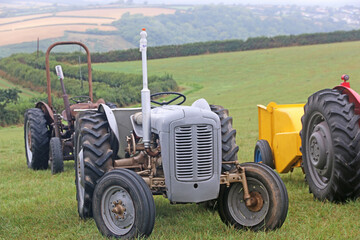 Obraz premium Vintage tractors standing in a field