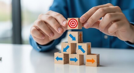 Person building a tower with wooden blocks