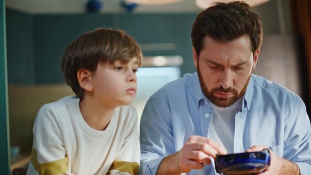 Father teaching son fix model automobile sitting kitchen closeup. Man repairing