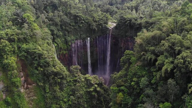 Aerial drone flight towards Tumpak Sewu waterfall and rainforest &ndash; Java, Indonesia