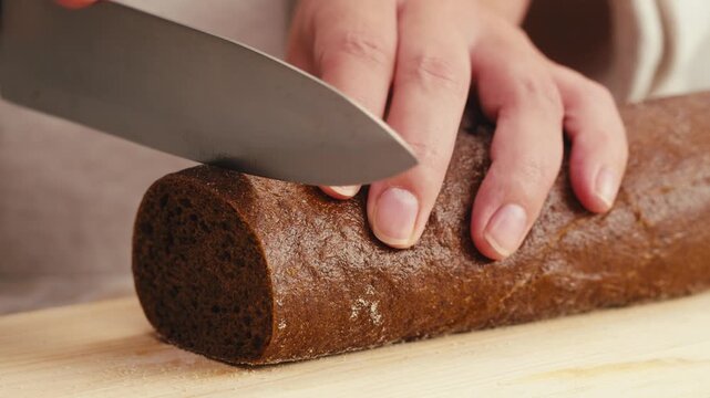 Black rye bread close up, dark brown sliced loaf, borodinsky slavic food, square slices with coriander on white background