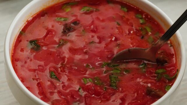 Beetroot soup, Cooking traditional national Slavic Russian, Ukranian soup Borsch close-up. Boiling red soup with vegetables and turkey meat and spices. Special red for Borsh from beet, tomatoes pasta