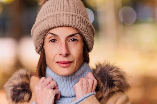 Woman wearing winter clothes looking at camera