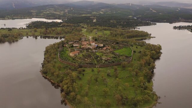 Aerial view of the ruins of Granadilla, a fortified medieval village in C&aacute;ceres, Spain, surrounded by Gabriel y Gal&aacute;n Reservoir. Historic walled town with castle tower and rural landscape in western I