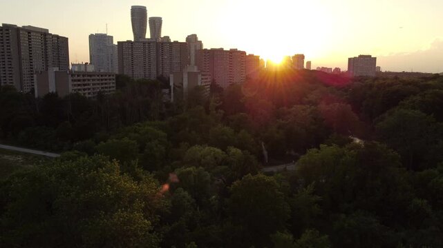 Aerial shot of the downtown city of Mississauga, Ontario, Canada skyline during sunset. Sun just below the horizon, with some lens flare.