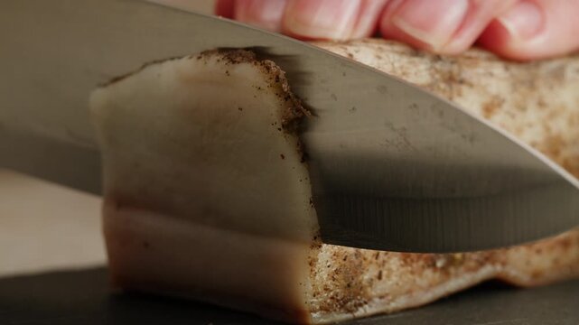 Salted lard bacon pork meat slicing in restaurant on kitchen, salo macro pork fat, black bread sandwich decorated with dill on white background close-up. Healthy fats. Healthy food. Vitamins