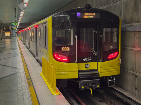 LOS ANGELES, CA, NOV 9, 2025: LA Metro D Line train displaying "Wilshire-Western" destination sits at subway station platform, yellow-black livery glowing