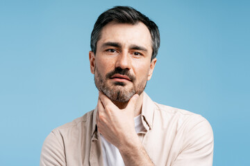 Man in deep thought touching beard, contemplating future decisions and ideas