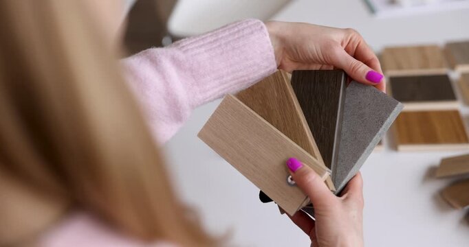 designer choosing skirting color from samples in interior design studio