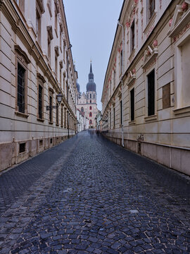 Historic Cobblestone Street Leading To St Nicholas Basilica In Trnava Slovakia