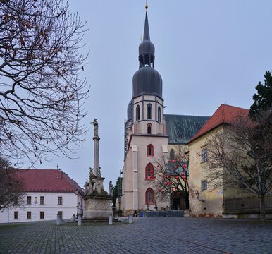 St Nicholas Basilica And Marian Column On Historic Cobblestone Square In Trnava