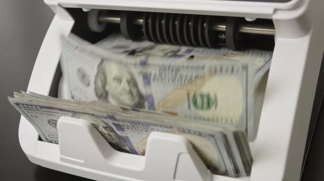 Money counting machine with motion bills. Money counting process. Paper money in counting machine. Business and finance concept with money. UDS in motion. Investment with cash dollars.