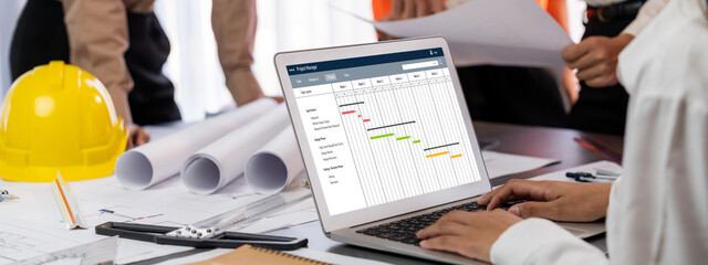 Project planning software for brisk business project management on the computer screen showing timeline chart of the team project © InfiniteFlow