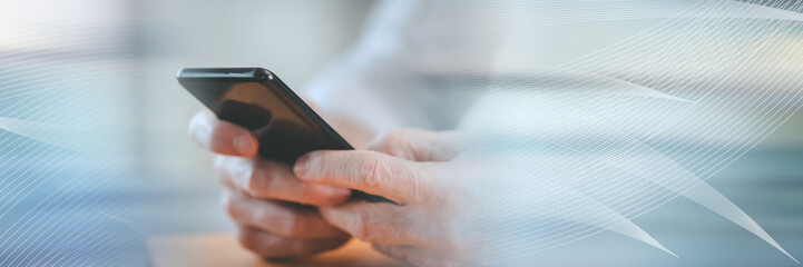 Hands using mobile phone; panoramic banner