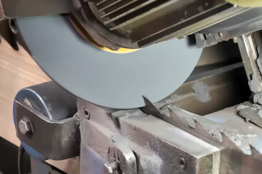 Sharpening the teeth of a band saw for a sawmill on a grinding machine with sharpening disk.