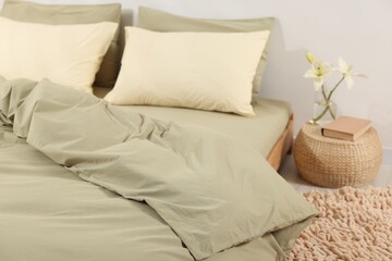 Comfortable bed with fresh cotton linens indoors, closeup