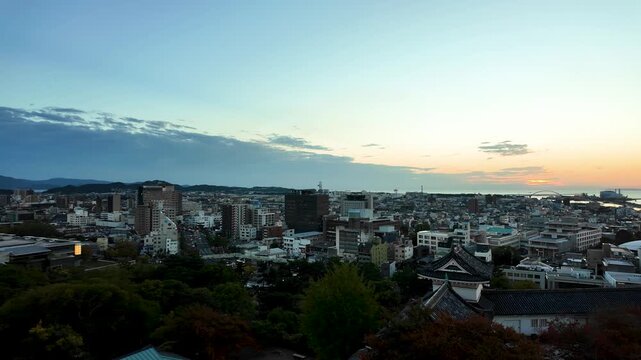 Panoramic Sunset View of Japanese City Skyline from Hilltop