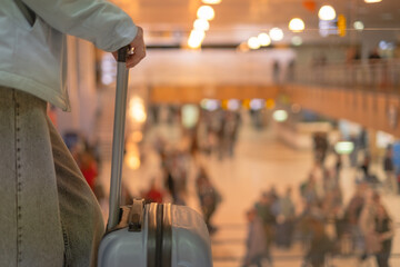 Travelers wait at the airport for their flights as they plan their next adventure to the sea for...