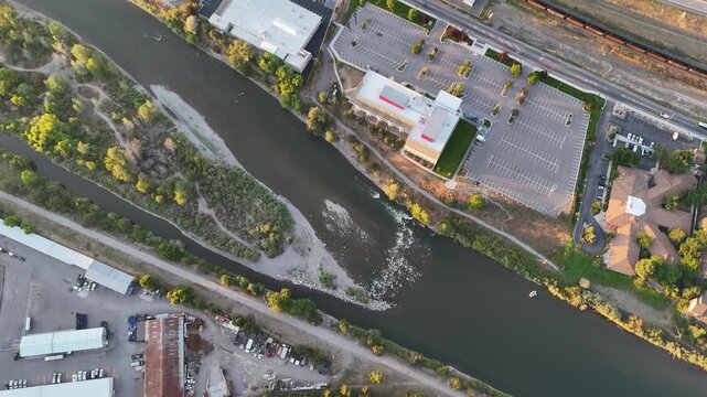 Top-down aerial drone video of the Clark Fork River and buildings in Missoula, Montana