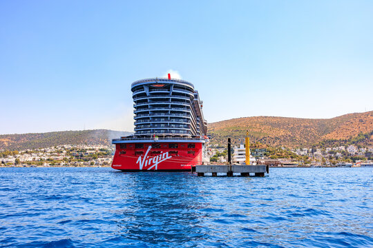 Luxury cruise ship virgin voyages in scenic harbor with hillside view. August 6, 2025, Bodrum Turkey