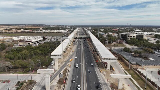 Overhead view of Interstate 10 and Loop 1604 highway interchange under construction in San Antonio, Texas 4K Aerial Drone Video