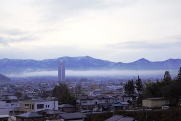 Obraz premium Cloudy morning landscape of Kaminoyama town with mountains Yamagata Japan