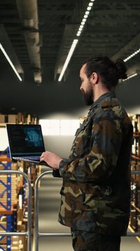 Vertical Video Armed forces staff leveraging artificial intelligence and cloud computing, warehouse logistics management. Black soldier reviewing AI software interface with neural networks for secure