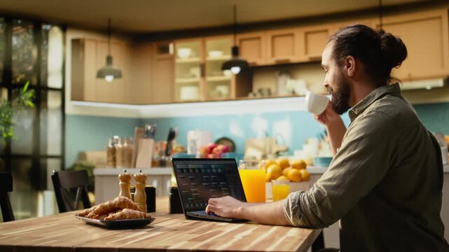 One person coding on laptop in a kitchen representing remote work in IT and software development. Programmer writes source code and uses command-line tools, highlighting engineering at home.