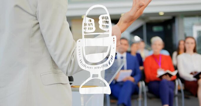 On cue speaker gesturing, checking pad, holding podium, guiding audience with white mic graphic