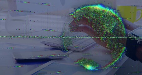 Typing right-hand holding stylus on white keyboard at desk, phone and papers beside data globe © vectorfusionart