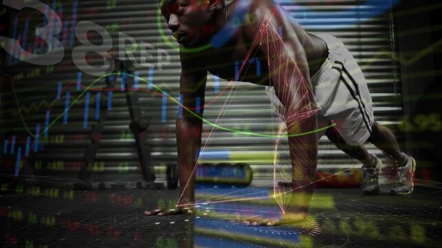 Man starting push-ups on gym floor holding plank while animated graphs mapping joints for training
