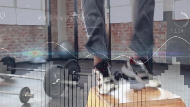 Male trainer stepping onto plyo box, doing explosive squats for power, graphs tracking progress