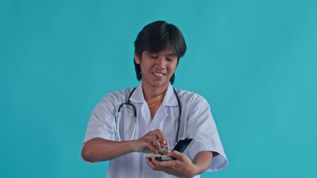 Male healthcare worker promoting digital hearing aid in small case 