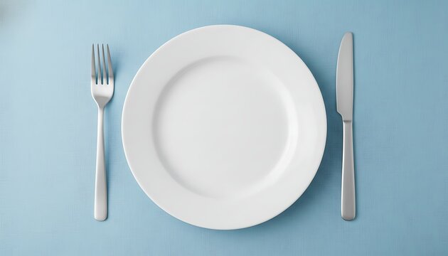 White Plate with Fork and Knife on Blue Table