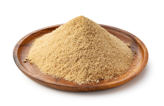 Fresh rice bran (Komenuka) powder in a wooden plate isolated on white background