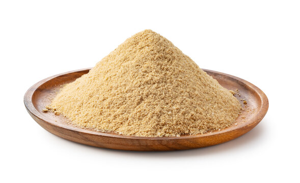 Fresh rice bran (Komenuka) powder in a wooden plate isolated on white background